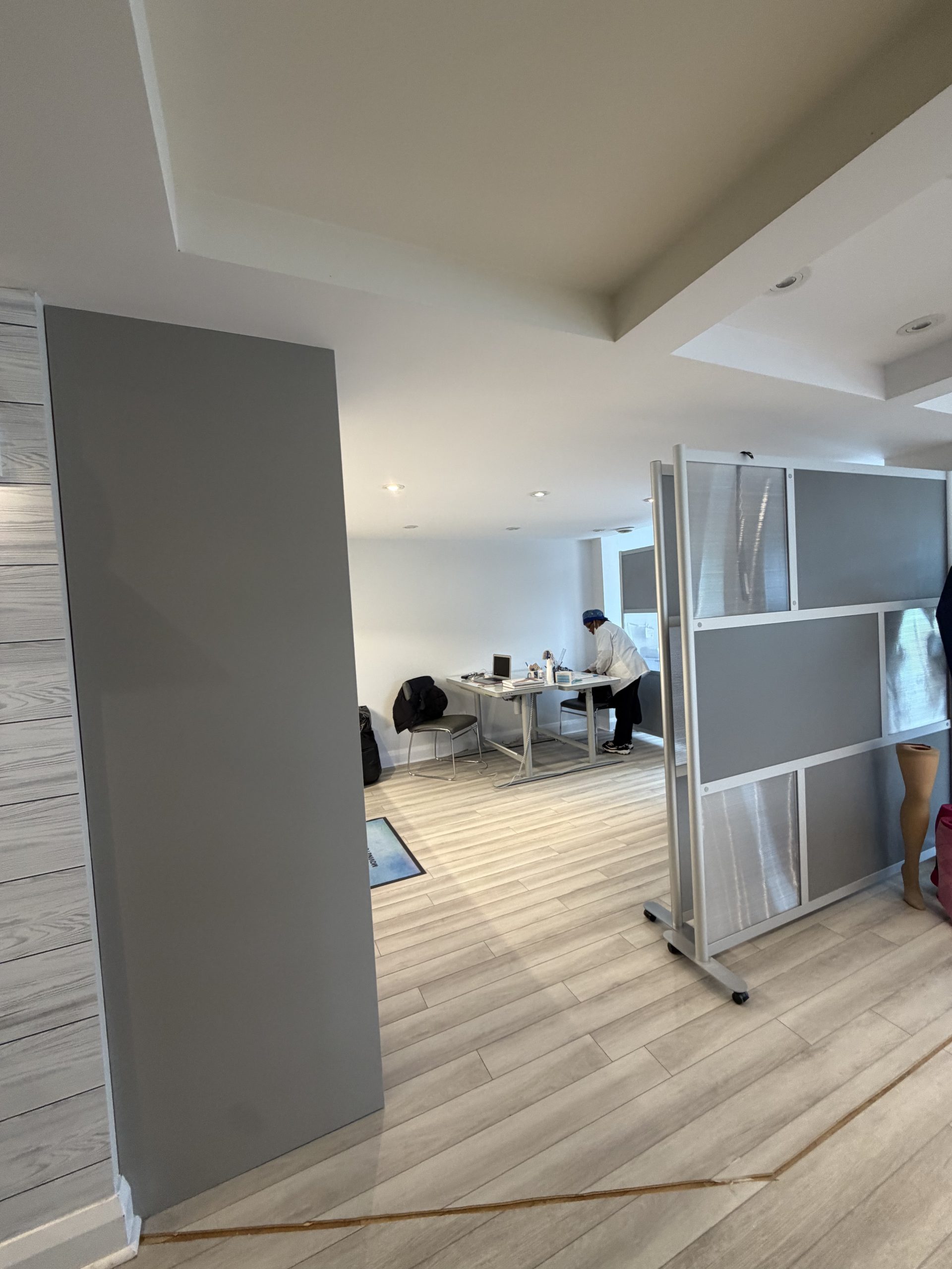 TiredSole™ clinic interior with privacy partitions and a workspace