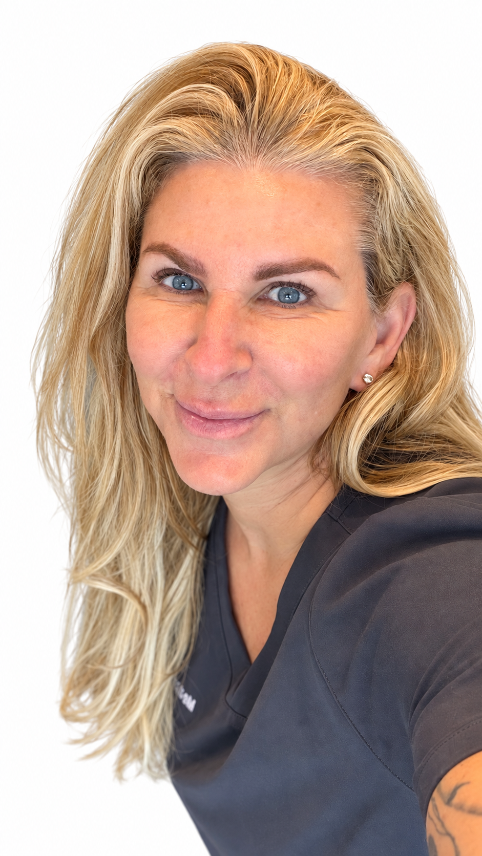 Lisa Garland wearing scrubs and a blue denim shirt